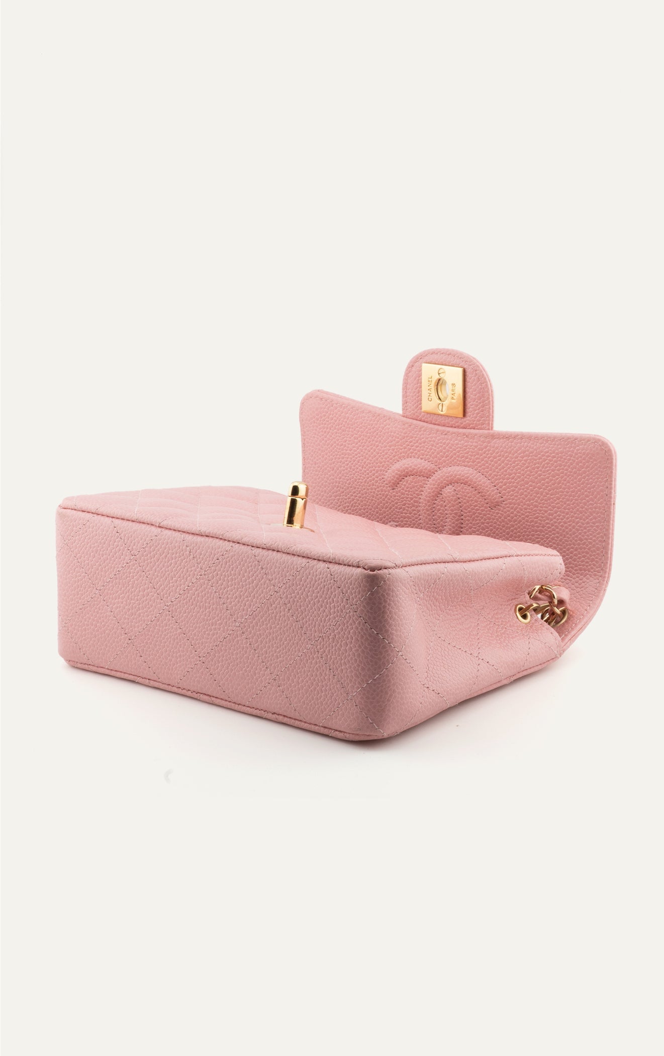 Vintage pink Chanel caviar mini square flap bag open with CC clasp
