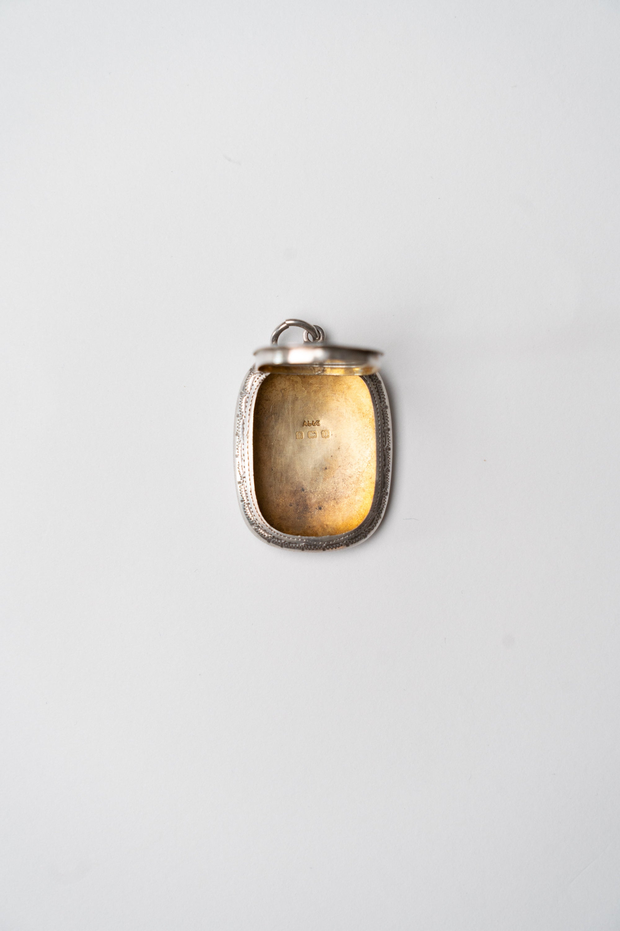 Antique engraved silver pendant case detail
